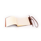 The Vintage Leather Sydney Leather Photo Book Memo features blank pages and a classic leather strap, lying open on a white surface—ideal for stylishly jotting thoughts or organizing notes.
