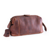 The Leather Travel Toiletry Bag Manchester by Vintage Leather Sydney is a stylish brown leather dopp kit with zipper closure and leather tag, photographed on a white background—perfect for organizing essentials on the go.