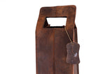 Close-up of the Banbury Wine Carry Bag by Vintage Leather Sydney, featuring full-grain leather, a rectangular handle cutout, and an embossed logo on a leather tag attached with a metal chain, set against a white background.