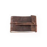 The Leather Photo Book Memo by Vintage Leather Sydney is a brown, leather-bound journal with a wraparound strap closure and visible white stitching, shown closed on a plain white background.